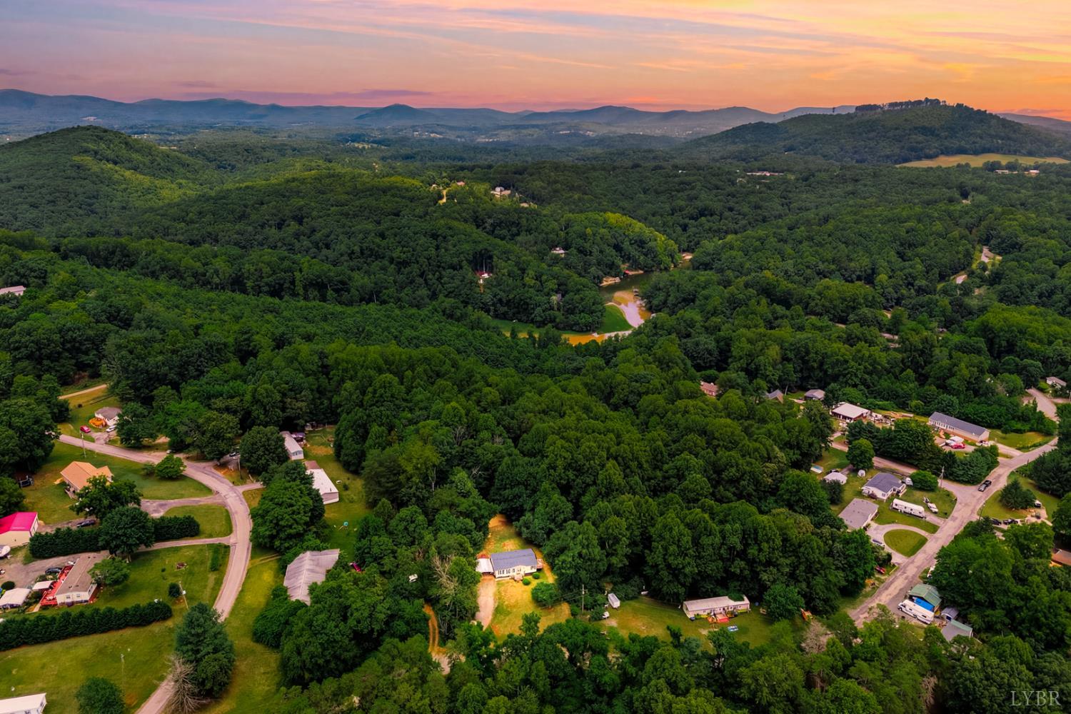 304 Ridgelake Road Goodview, VA 24095 - Photo 3 of 29 an aerial view of green landscape with trees houses and mountain view