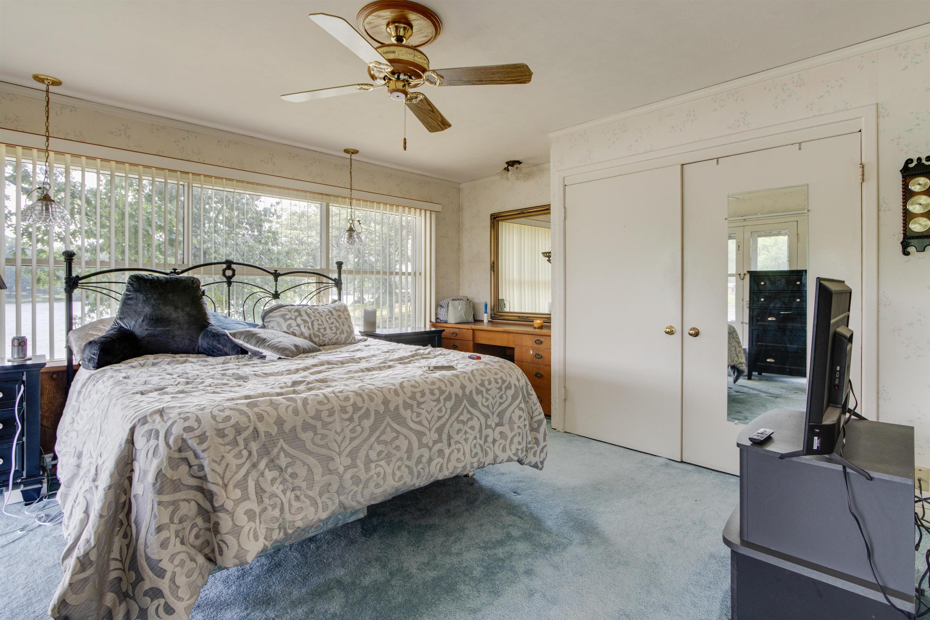 4920 Coro Road Memphis, TN 38109 - Photo 18 of 25 a bedroom with a bed and large mirror