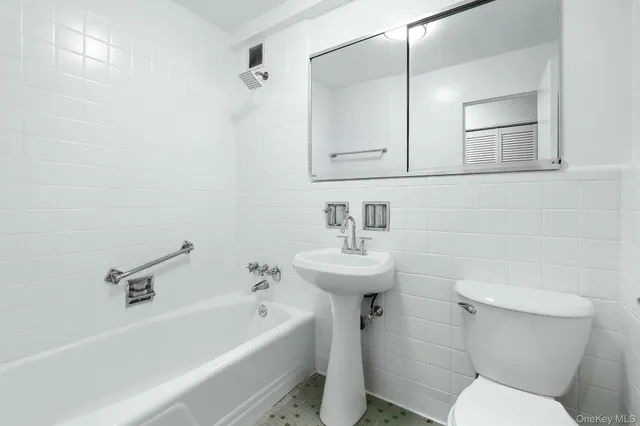 a bathroom with a sink a toilet and bathtub