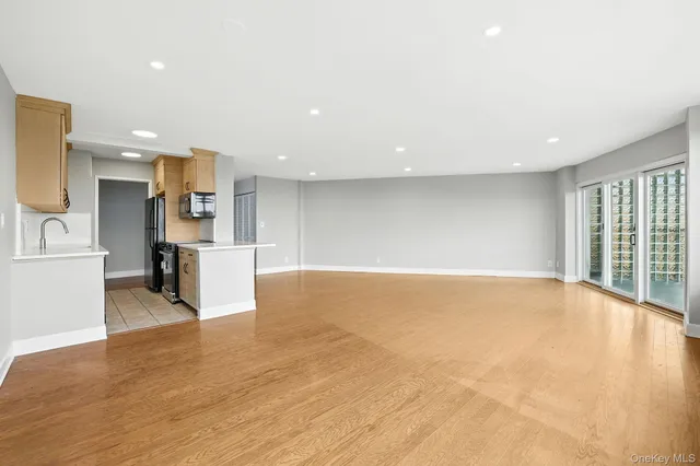 a view of kitchen and kitchen with a sink wooden cabinets and outdoor space
