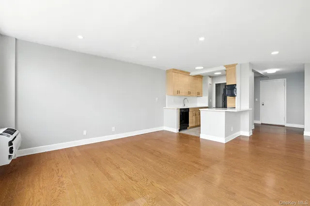 a view of kitchen with kitchen island white cabinets and refrigerator