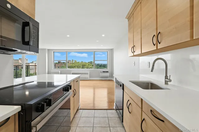 a kitchen with stainless steel appliances granite countertop a sink and a microwave