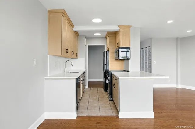 a kitchen with a sink cabinets and wooden floor
