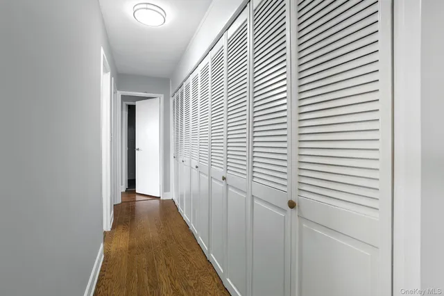 a view of a hallway with a wooden floor