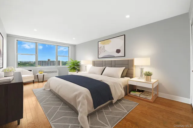 a bedroom with a bed and a large window