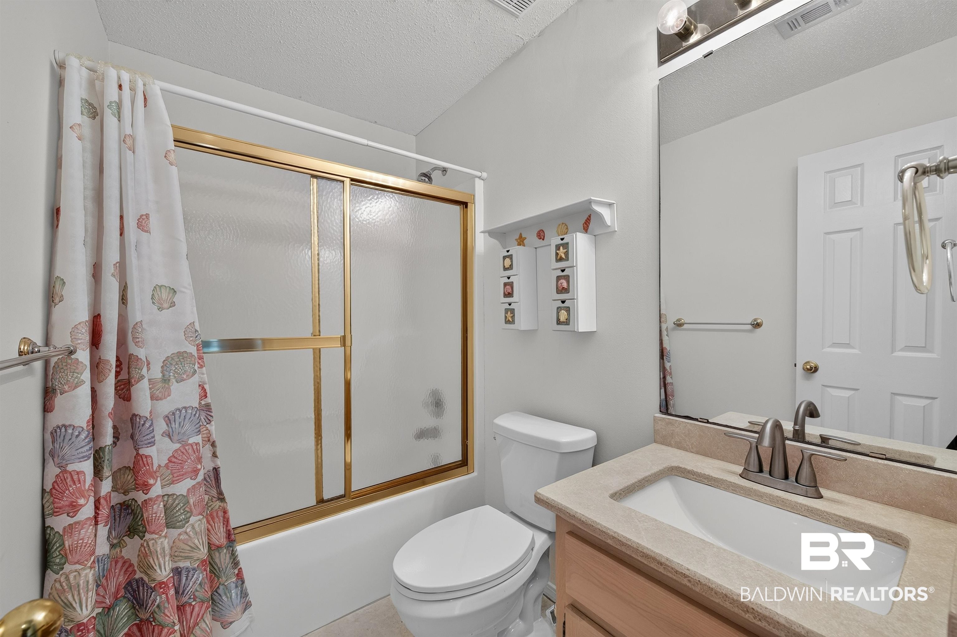 22685 County Road 12 Foley, AL 36535 - Photo 66 of 89 Bathroom featuring a vanity with a light-toned countertop and an integrated sink, a large wall-mounted mirror, and a shower-tub combination with sliding glass doors