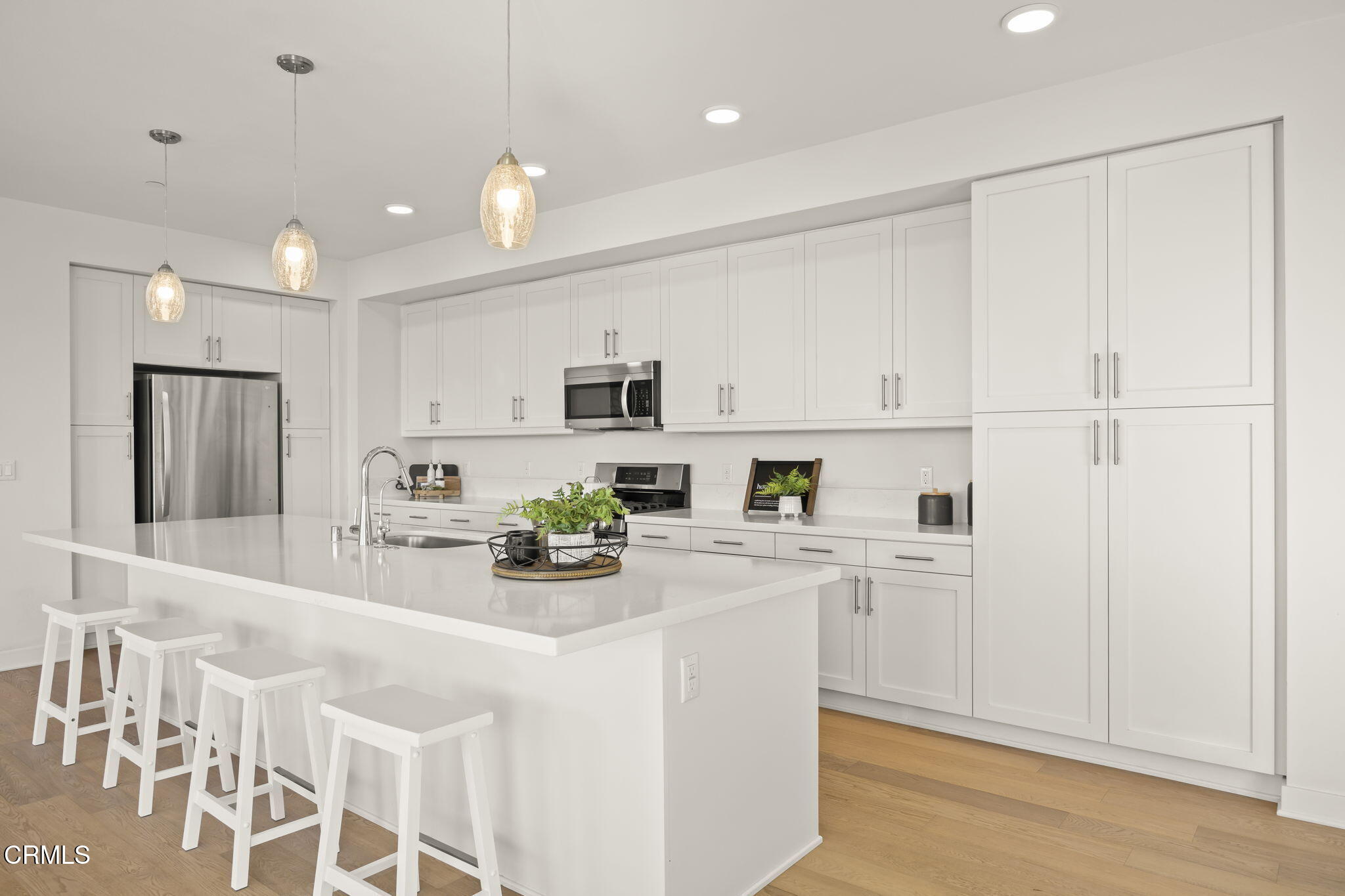 2800 Wagon Wheel Road, Unit 404 Oxnard, CA 93036 - Photo 12 of 43 a kitchen with white cabinets and stainless steel appliances