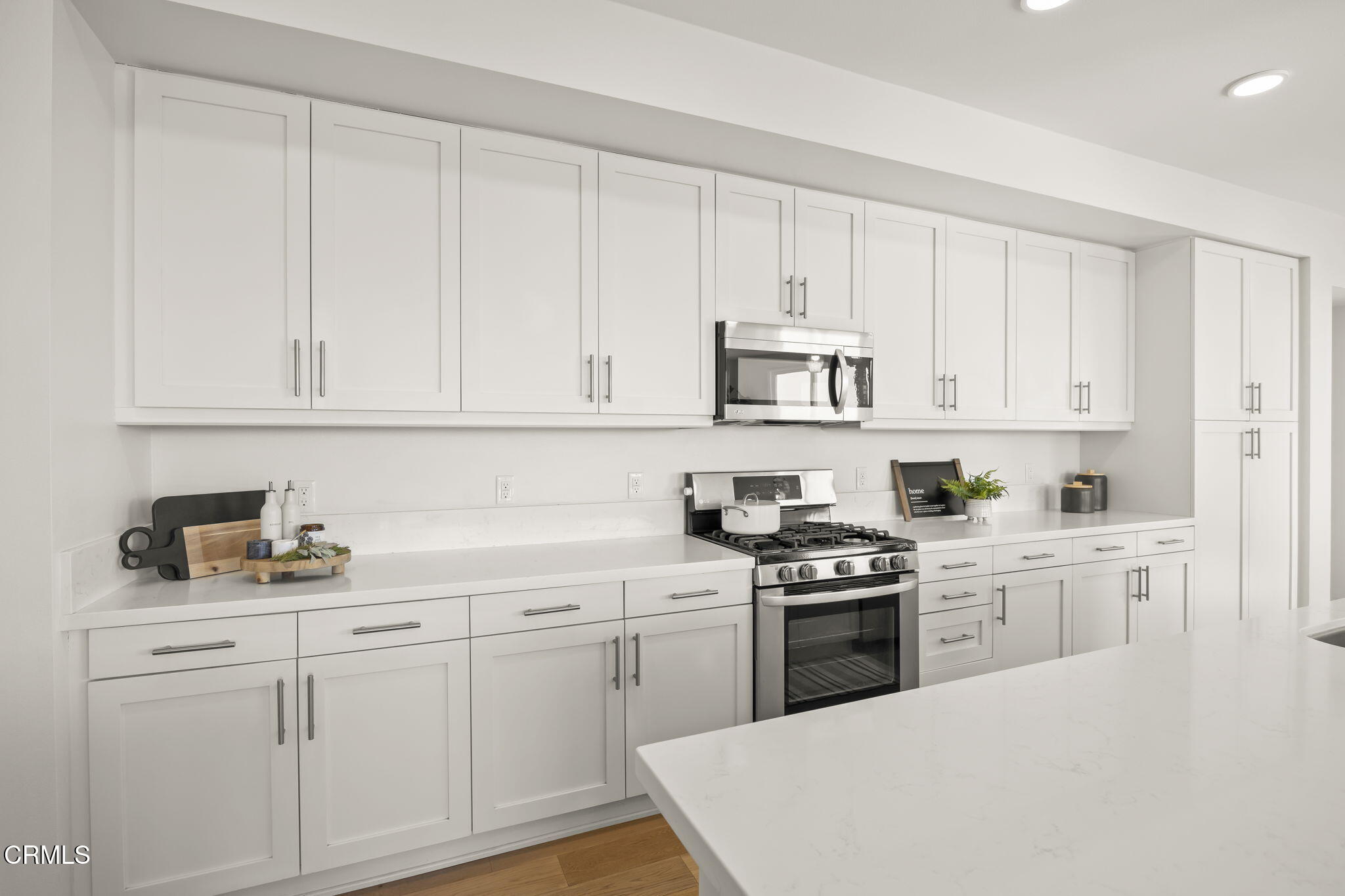 2800 Wagon Wheel Road, Unit 404 Oxnard, CA 93036 - Photo 13 of 43 a kitchen with white cabinets and white appliances