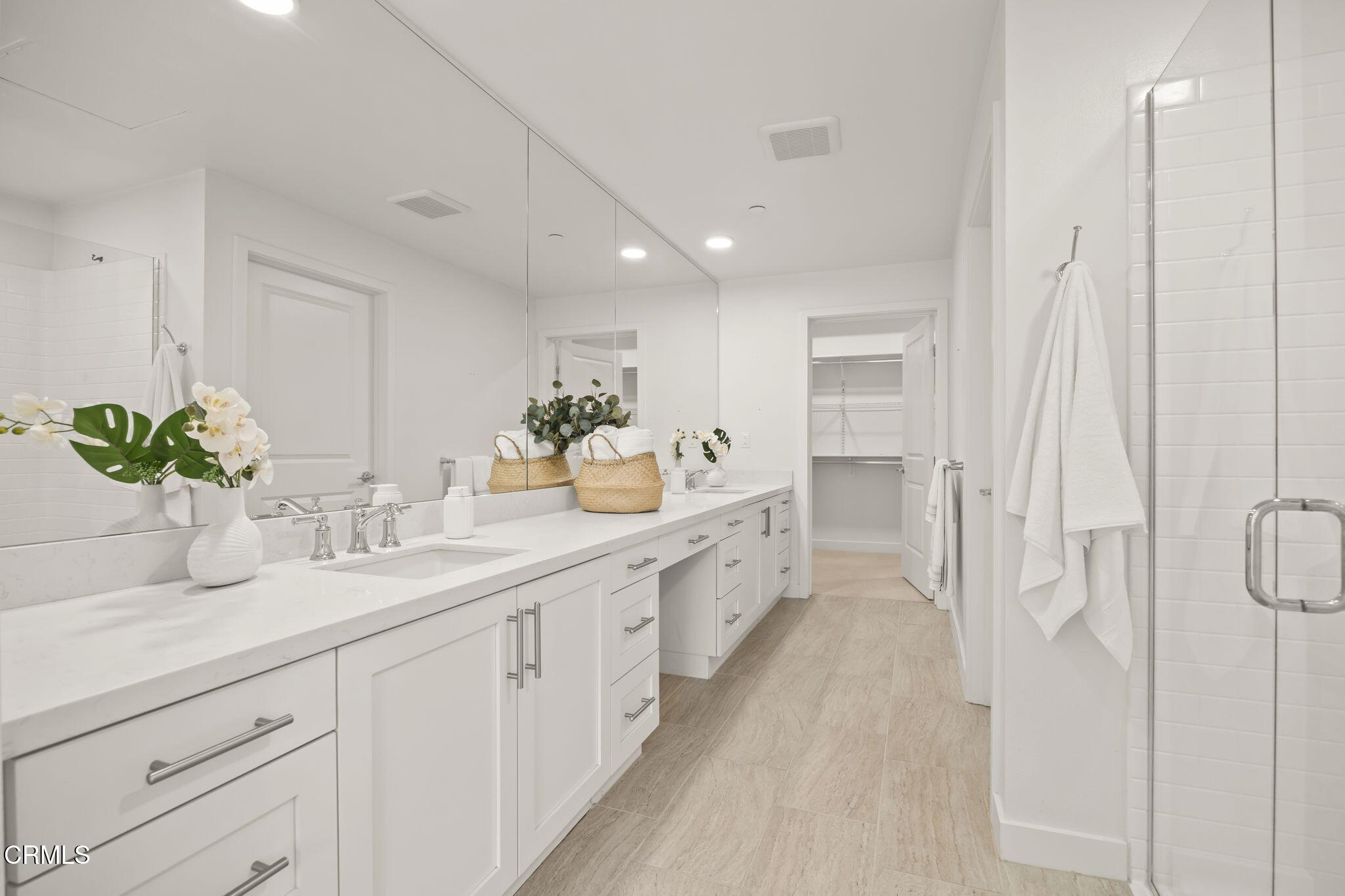 2800 Wagon Wheel Road, Unit 404 Oxnard, CA 93036 - Photo 27 of 43 a spacious bathroom with a double vanity sink a mirror and a shower