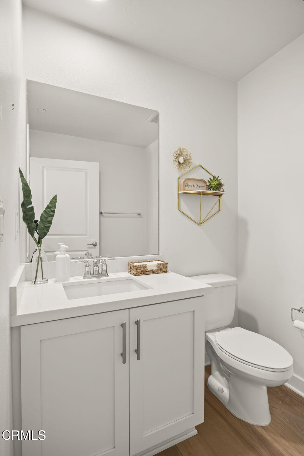 2800 Wagon Wheel Road, Unit 404 Oxnard, CA 93036 - Photo 35 of 43 a bathroom with a toilet sink and mirror