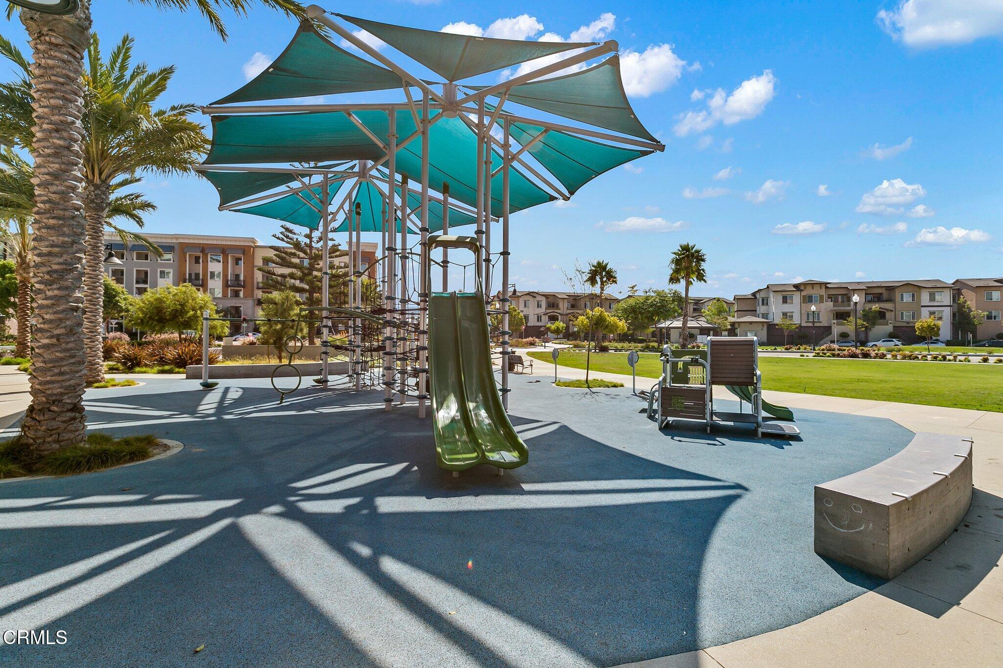 2800 Wagon Wheel Road, Unit 404 Oxnard, CA 93036 - Photo 39 of 43 a view of a patio with a table and chairs under an umbrella