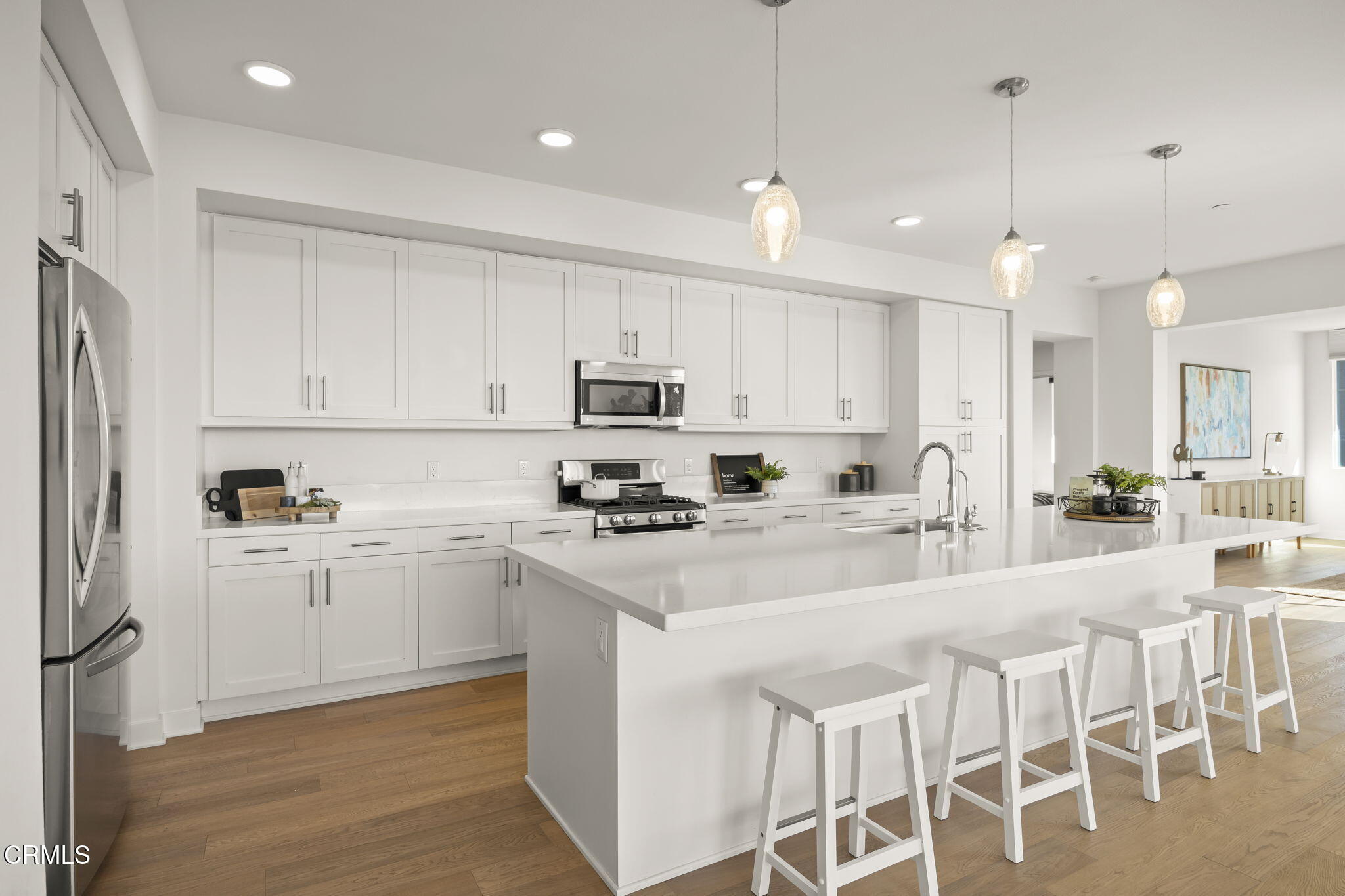2800 Wagon Wheel Road, Unit 404 Oxnard, CA 93036 - Photo 10 of 43 a large white kitchen with cabinets