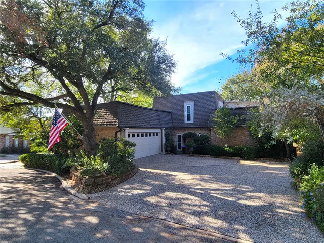a front view of a house with a yard and tree s