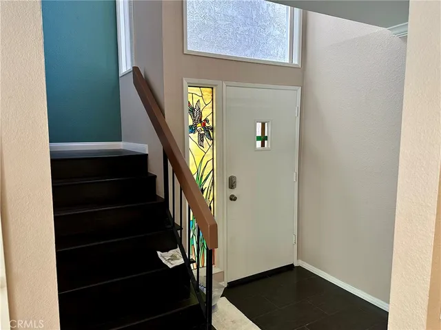 a view of entryway with wooden floor and stairs
