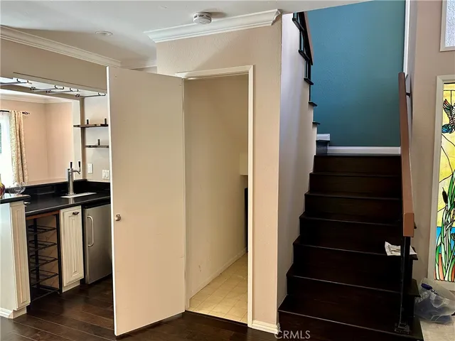 a view of a hallway with wooden floor and entryway