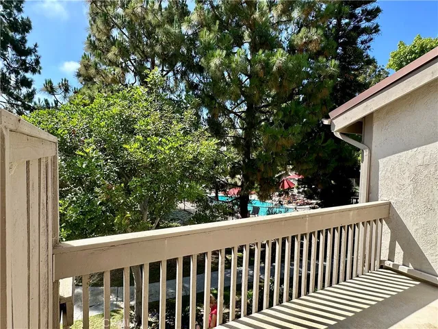 a view of a balcony with flower plants