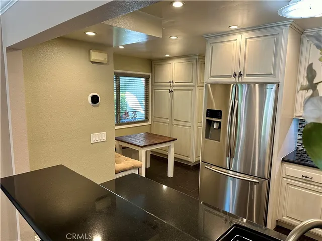 a kitchen with stainless steel appliances a refrigerator and a stove