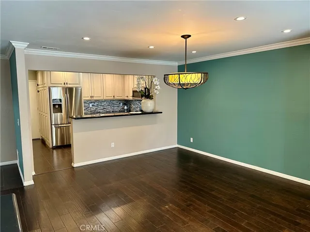 a view of a kitchen with a ceiling fan and a wooden floor