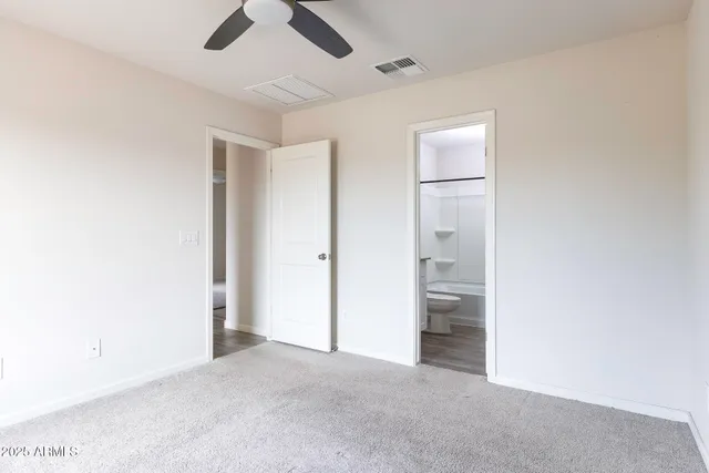 a view of empty room with ceiling fan