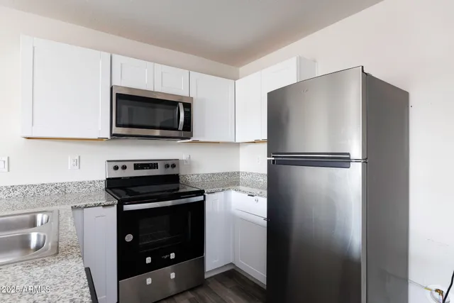 a kitchen with a refrigerator stove and microwave