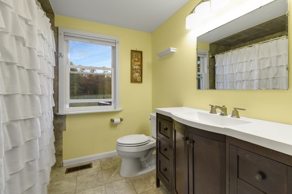 224 Lancaster Road Berlin, MA 01503 - Photo 14 of 32 a bathroom with a toilet sink and mirror