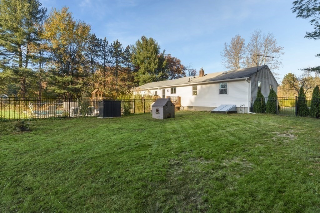 224 Lancaster Road Berlin, MA 01503 - Photo 25 of 32 a backyard of a house with table and chairs
