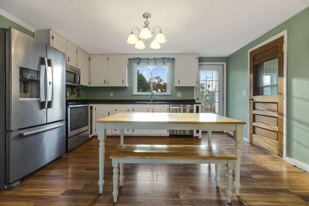 224 Lancaster Road Berlin, MA 01503 - Photo 3 of 32 a kitchen with a stove a refrigerator and cabinets