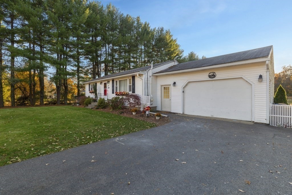 224 Lancaster Road Berlin, MA 01503 - Photo 31 of 32 a view of a house with a yard and garage