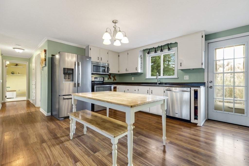 224 Lancaster Road Berlin, MA 01503 - Photo 4 of 32 a kitchen with stainless steel appliances granite countertop a stove and a refrigerator