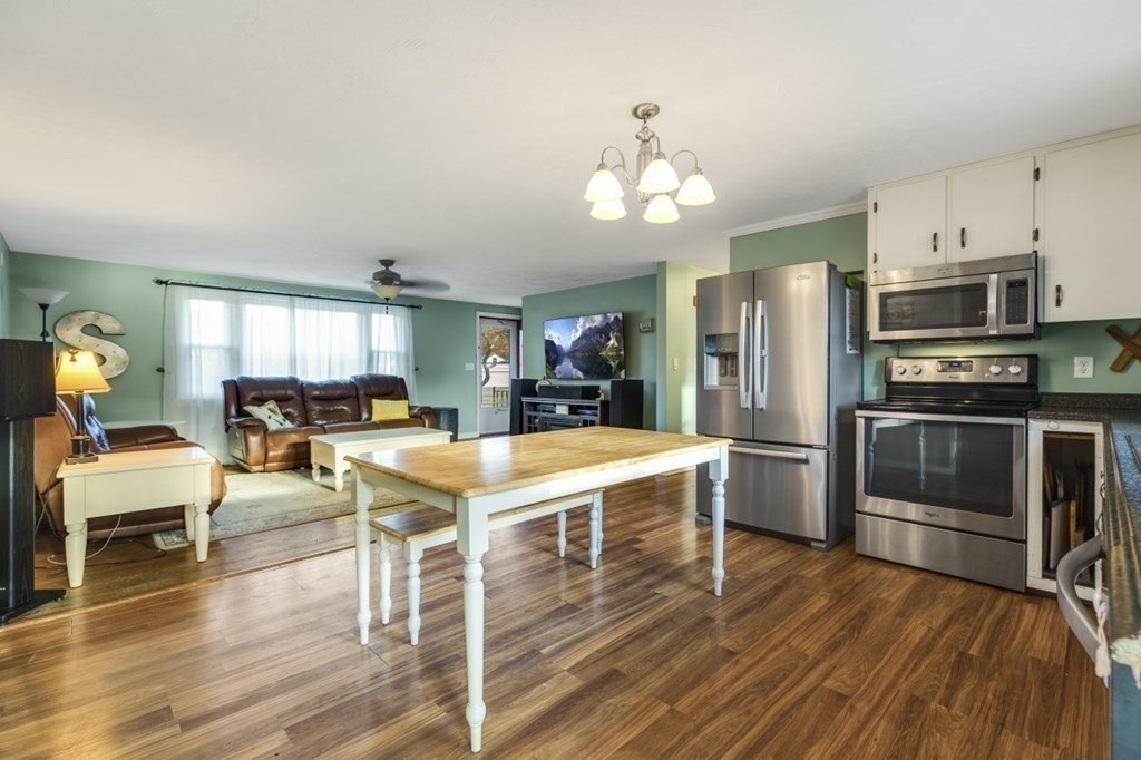 224 Lancaster Road Berlin, MA 01503 - Photo 6 of 32 a kitchen with stainless steel appliances a table chairs refrigerator and cabinets