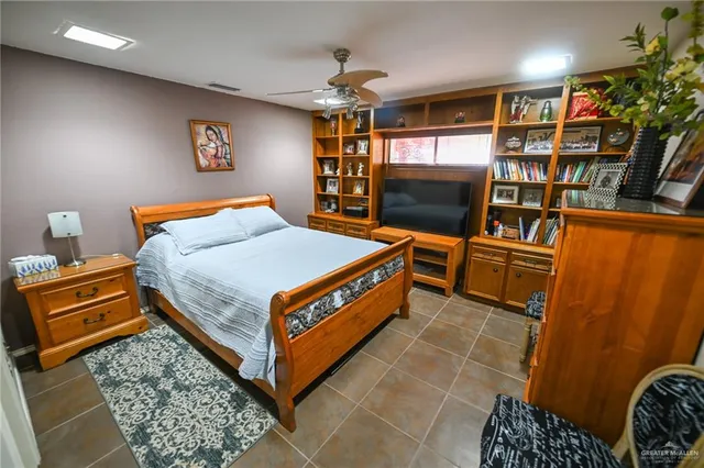 a bed room with a bed and a book shelf