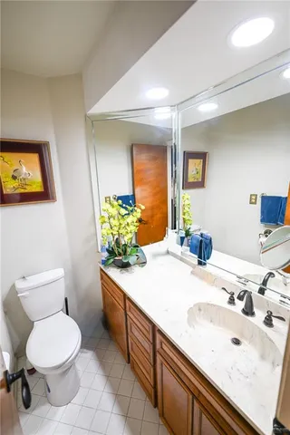 a bathroom with a sink a toilet and mirror
