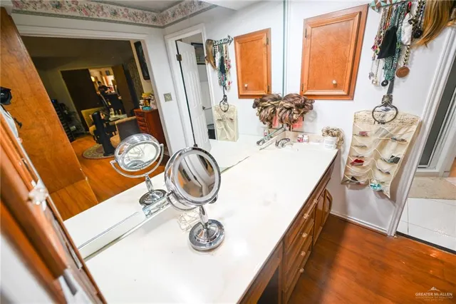 a bedroom with a bed a flat screen tv and wall