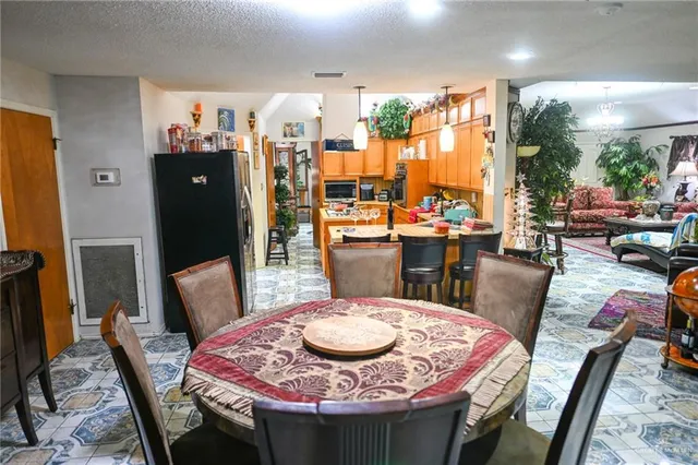 a dining table with chairs and window