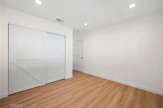 an empty room with wooden floor