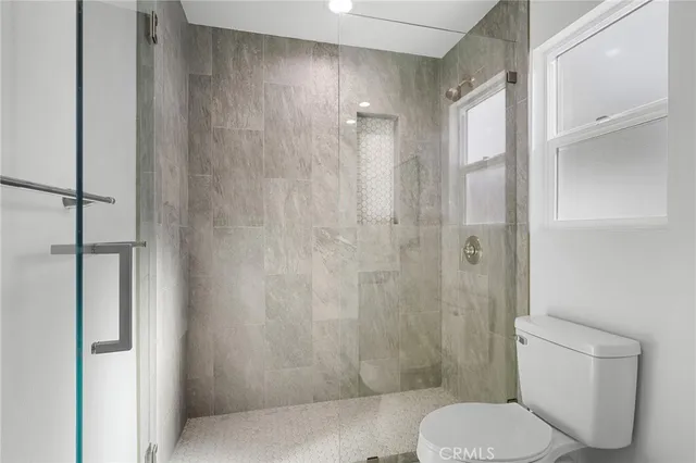 a bathroom with a toilet and a shower