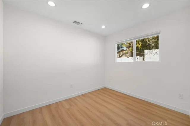 a view of room with wooden floor and fan