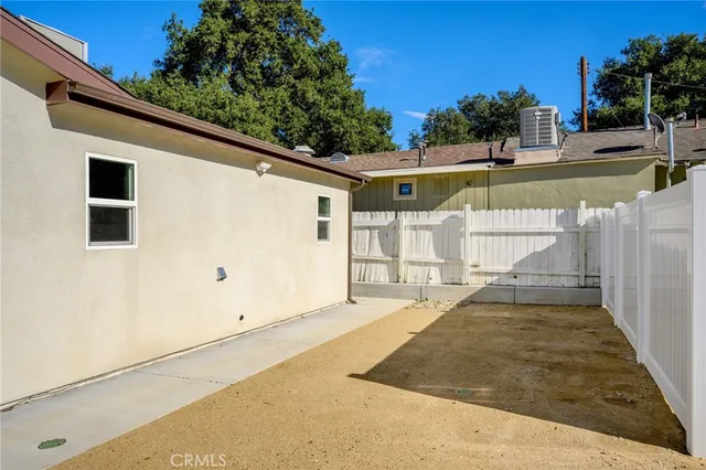 a view of a house with a backyard