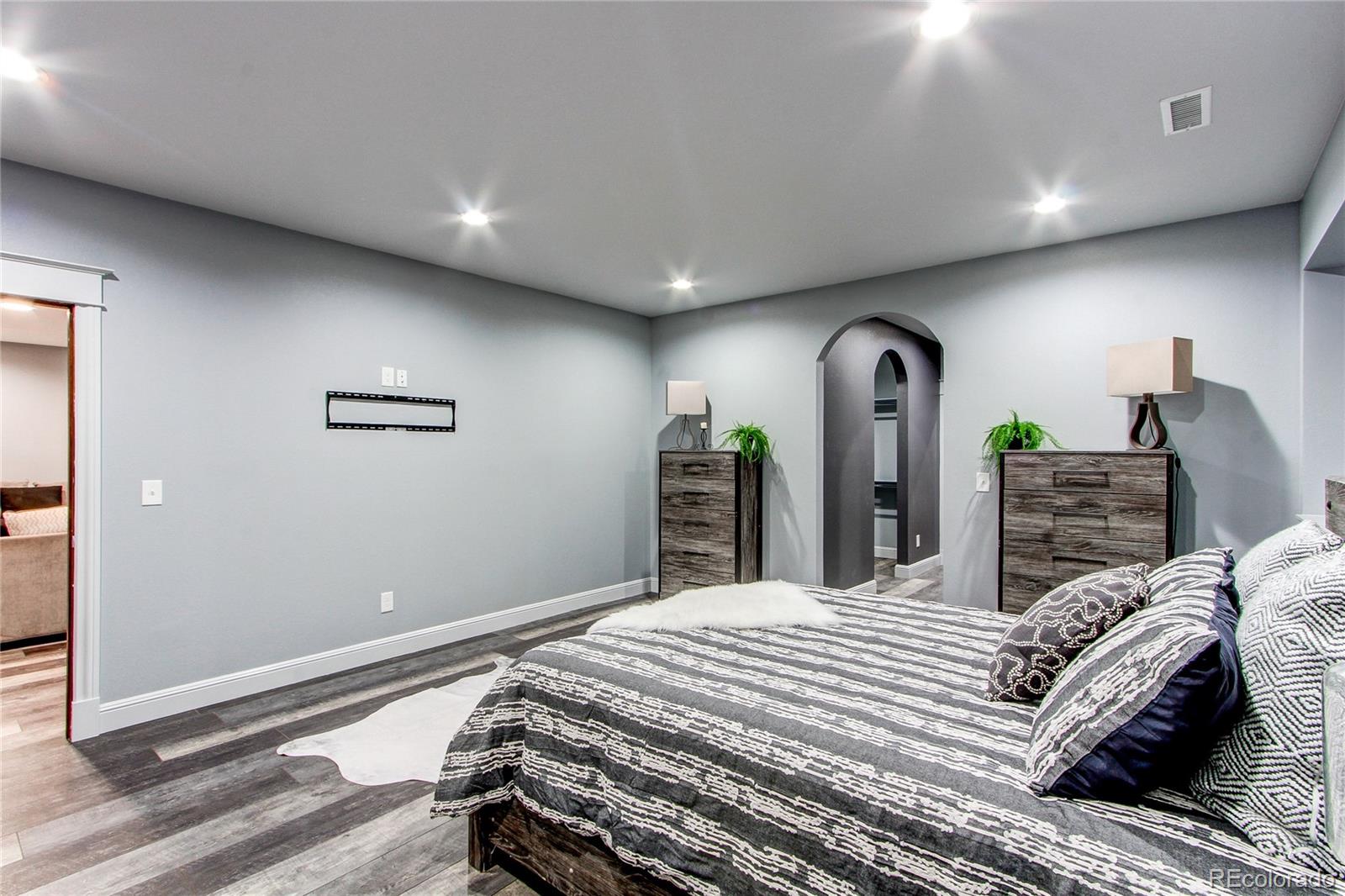 6001 Xmore Road Byers, CO 80103 - Photo 13 of 48 a bedroom with a bed and a large mirror