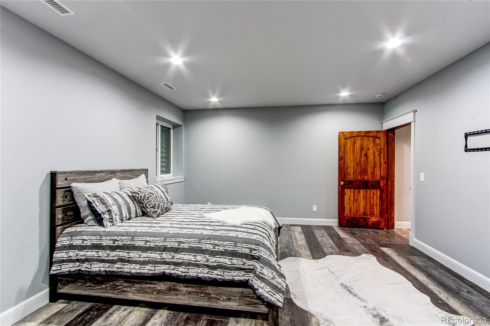 6001 Xmore Road Byers, CO 80103 - Photo 14 of 48 a bedroom with a large bed and a window