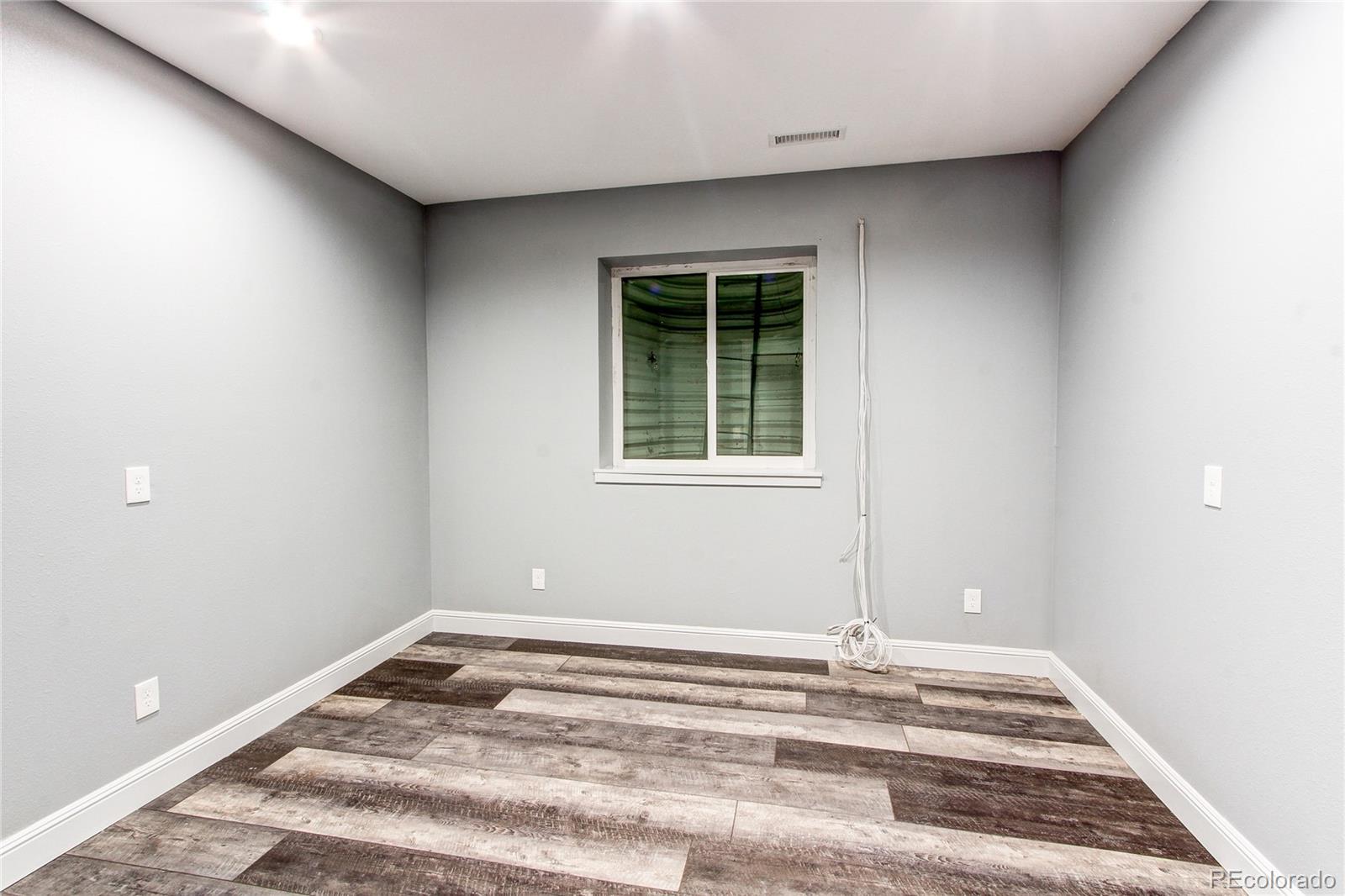 6001 Xmore Road Byers, CO 80103 - Photo 20 of 48 a view of a livingroom with wooden floor and a window