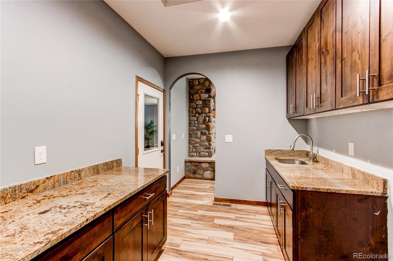 6001 Xmore Road Byers, CO 80103 - Photo 22 of 48 a kitchen with a sink a stove and cabinets