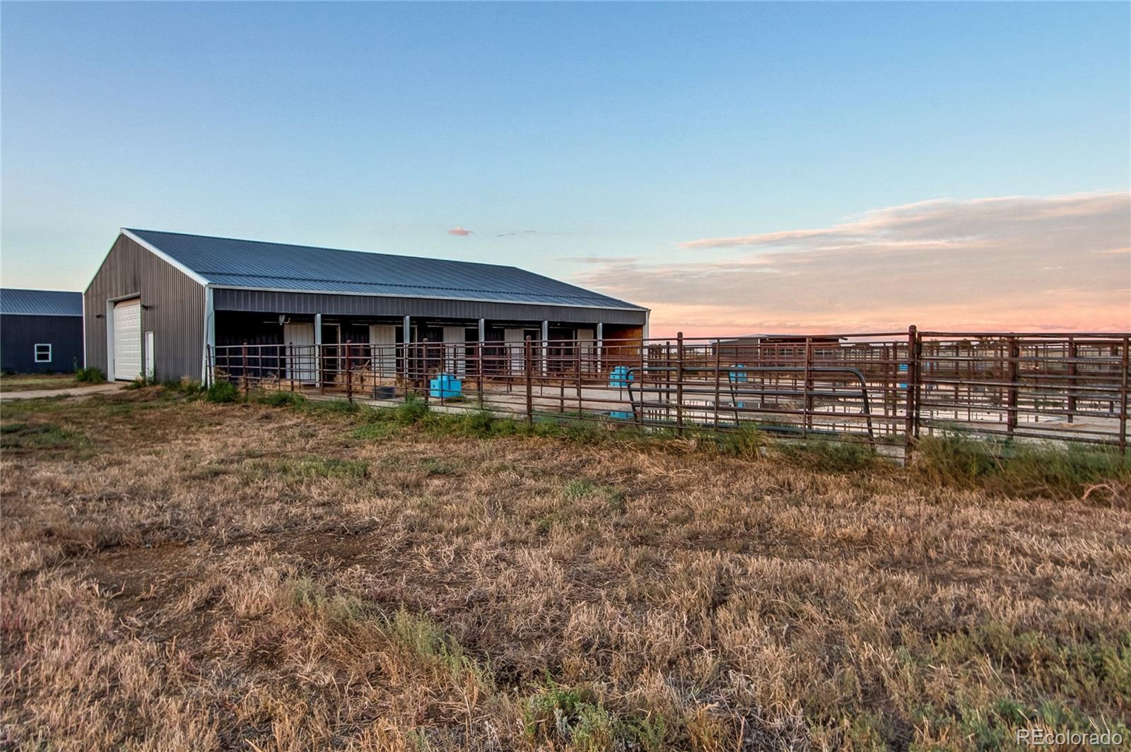 6001 Xmore Road Byers, CO 80103 - Photo 24 of 48 front view of a house with a yard
