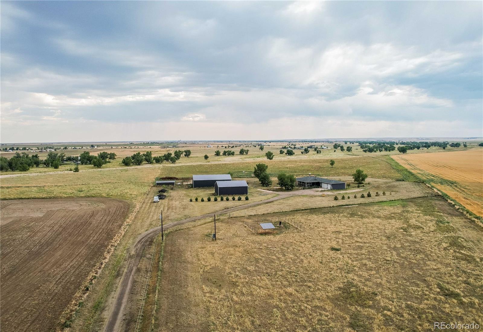 6001 Xmore Road Byers, CO 80103 - Photo 28 of 48 an aerial view of residential building and lake view