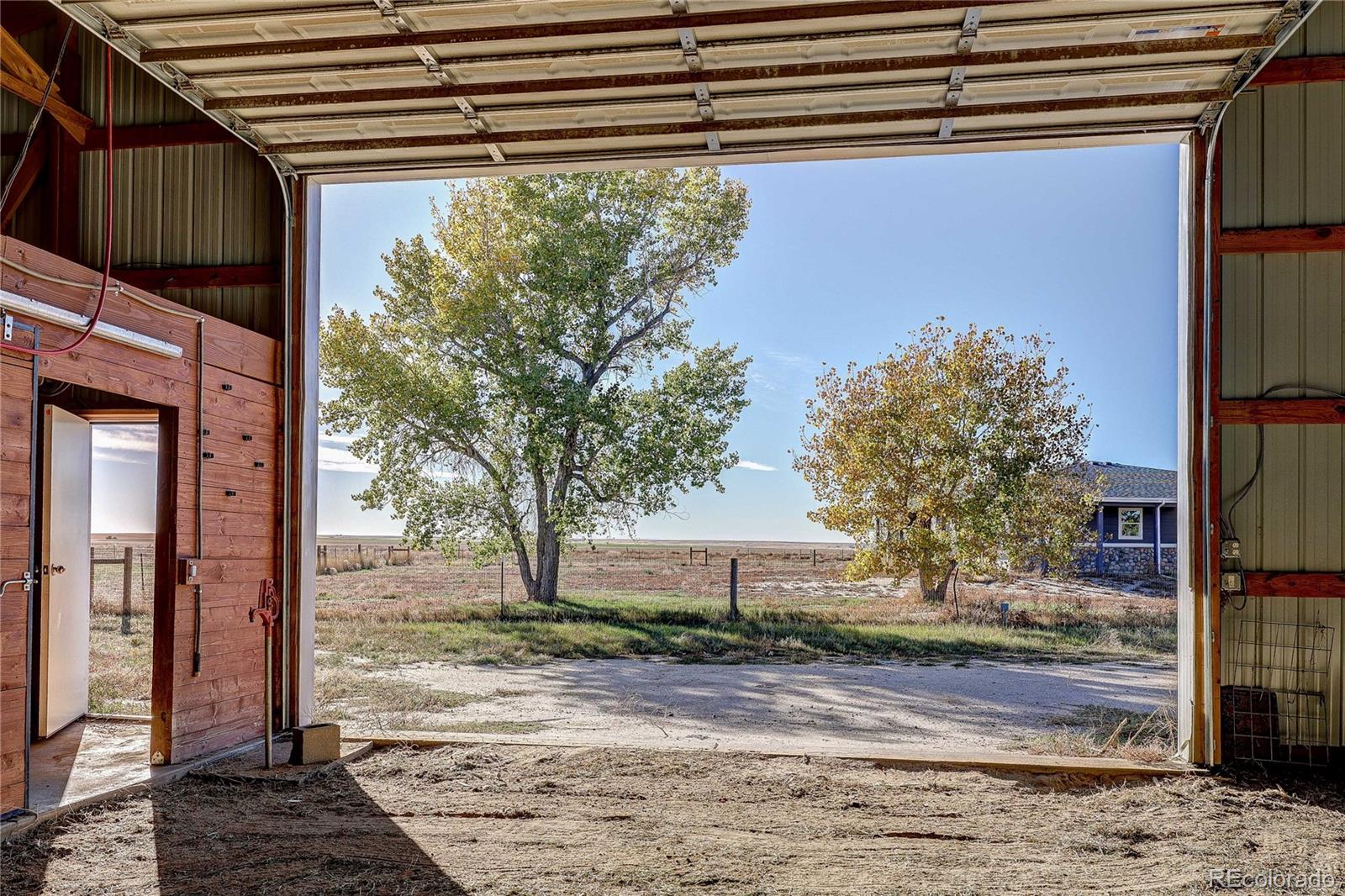 6001 Xmore Road Byers, CO 80103 - Photo 40 of 48 a front view of a house with garden