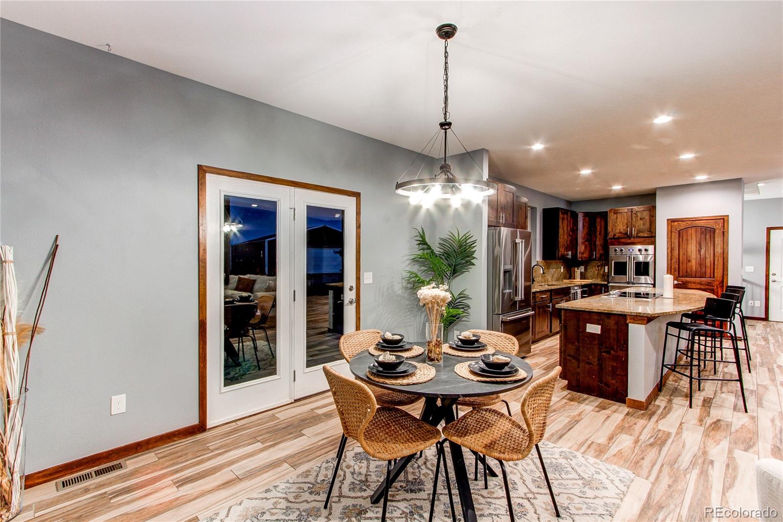 6001 Xmore Road Byers, CO 80103 - Photo 5 of 48 a view of a dining room with furniture window and wooden floor