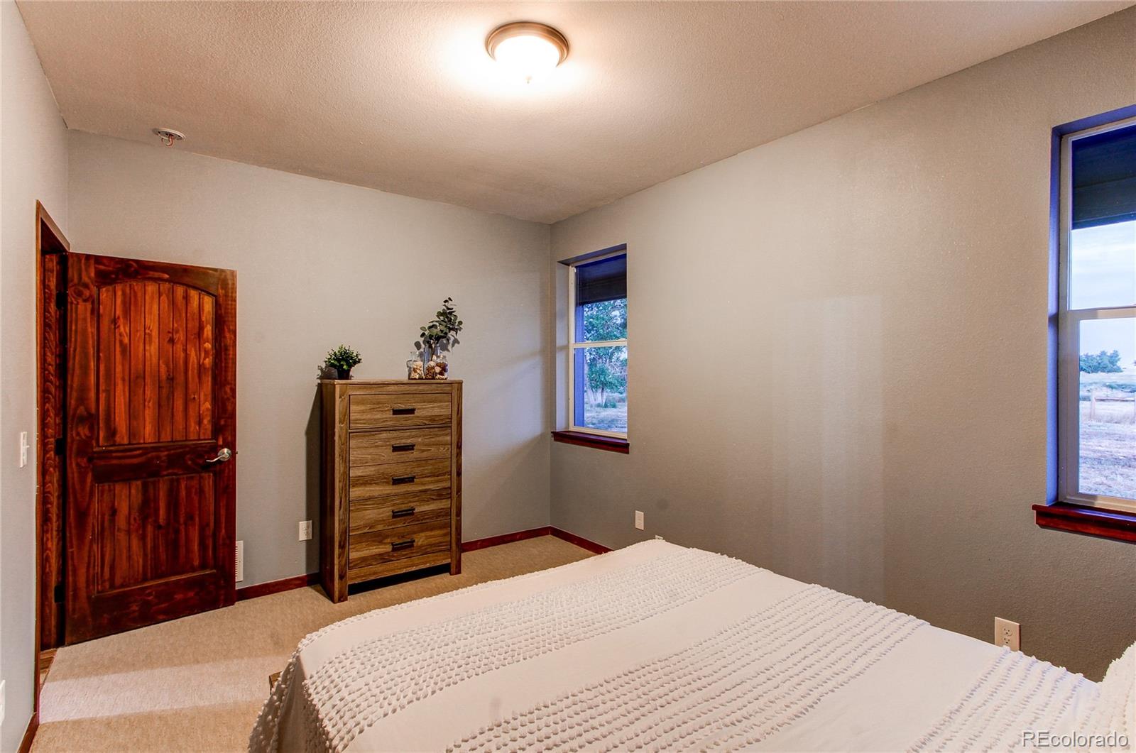 6001 Xmore Road Byers, CO 80103 - Photo 8 of 48 a bedroom with a bed and furniture