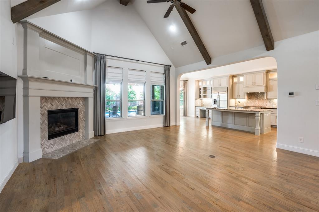 10482 Tobias Lane Frisco, TX 75033 - Photo 12 of 40 a view of an empty room and kitchen with a fireplace