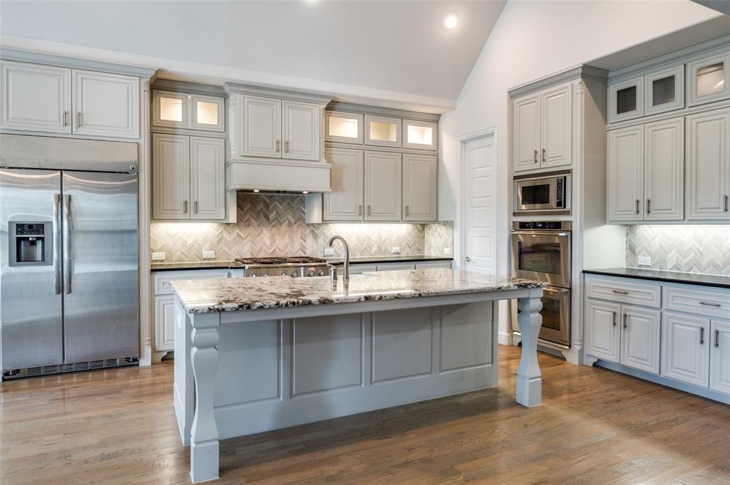 10482 Tobias Lane Frisco, TX 75033 - Photo 14 of 40 a kitchen with stainless steel appliances granite countertop a stove refrigerator sink and cabinets
