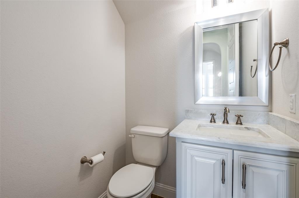 10482 Tobias Lane Frisco, TX 75033 - Photo 17 of 40 a bathroom with a toilet sink and mirror